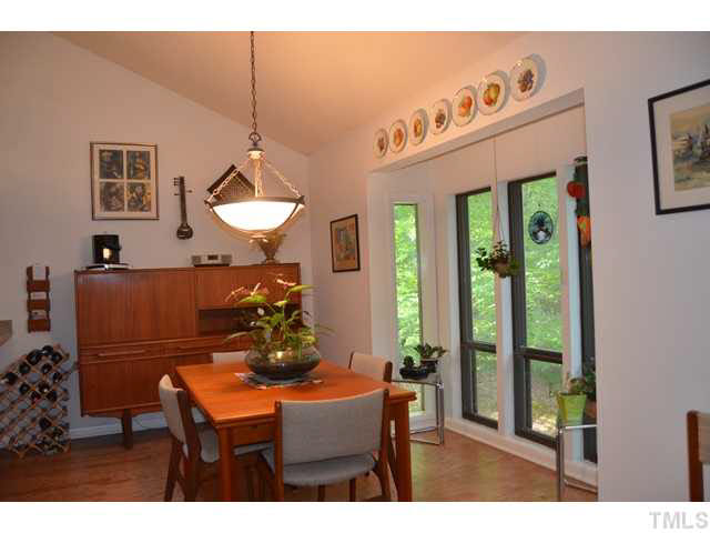 245 Fox Ridge Pittsboro, NC 27312 - Photo 7 of 25 The dining room is adjacent to the kitchen and has a boxed bay window, cathedral ceiling, and plenty of wall space for accompanying pieces.