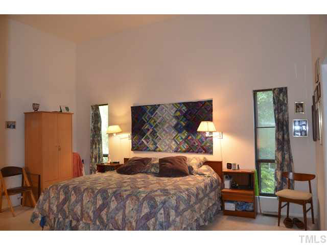 245 Fox Ridge Pittsboro, NC 27312 - Photo 10 of 25 The master bedroom is oversized and has great wall space, volume ceiling, its own private bath, and access to the sunroom.