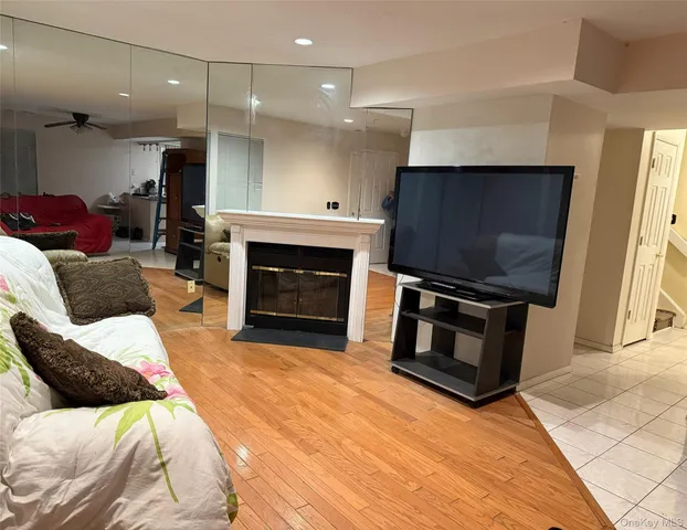 a living room with furniture a flat screen tv and a fireplace