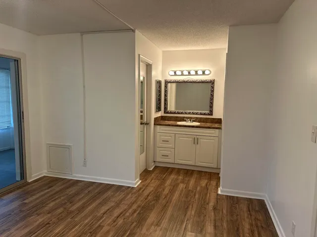 a view of kitchen with wooden floor and electronic appliances