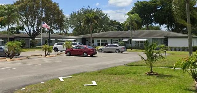 a car parked in front of a house with a fountain