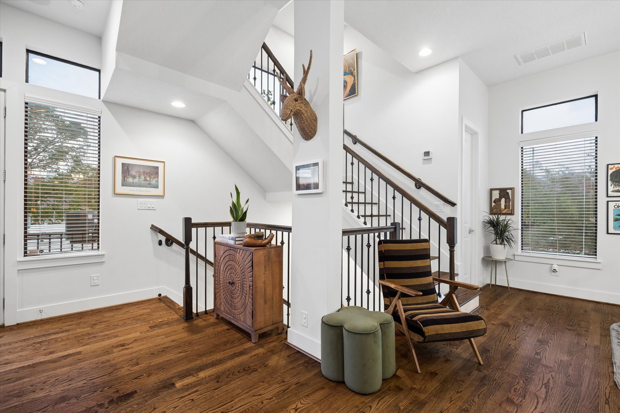 2110 Genesee Street Houston, TX 77006 - Photo 19 of 47 a view of the landing from the second level. The half bath is discreetly positioned to the right of the stairs leading to level three.