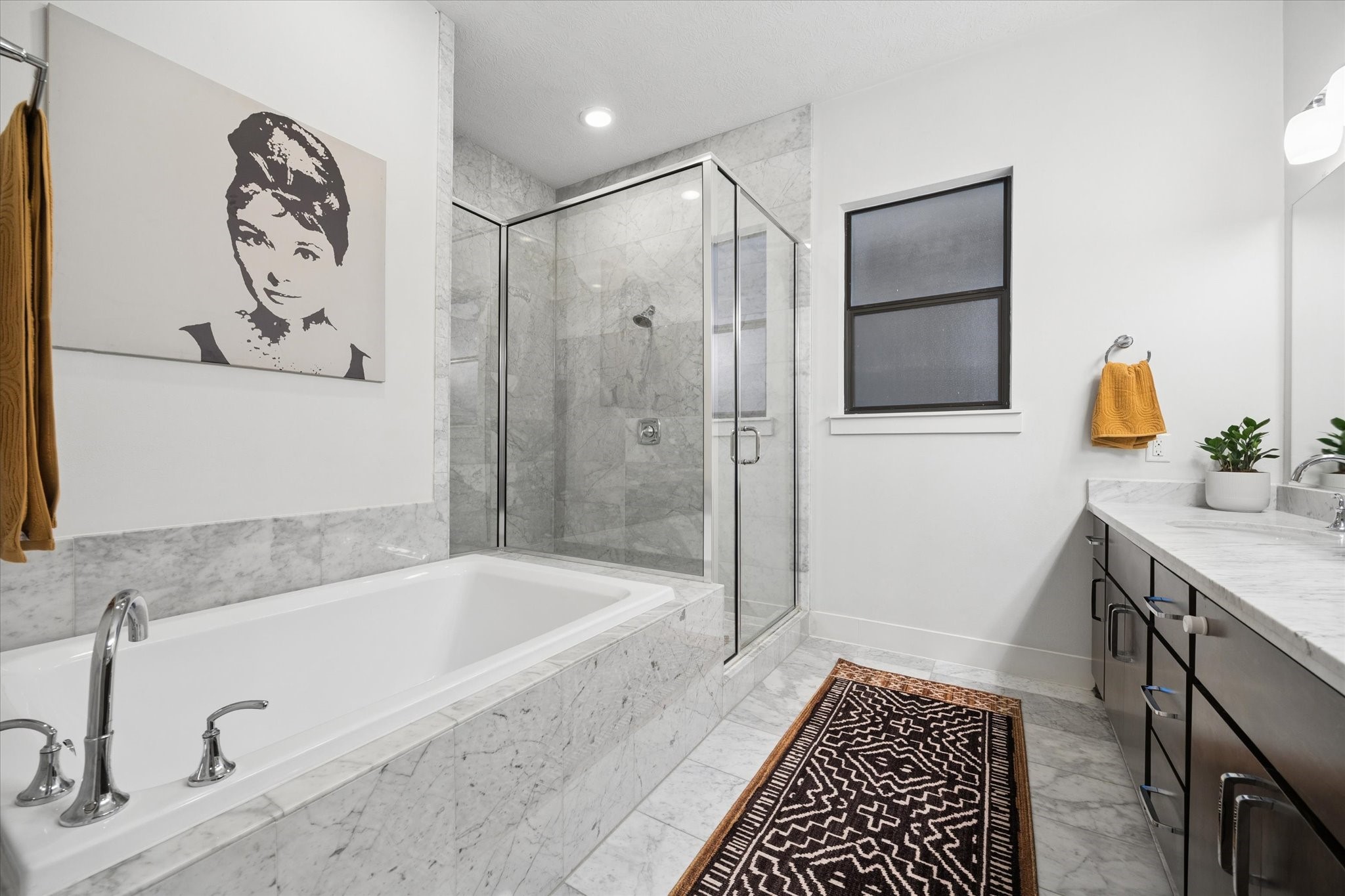 2110 Genesee Street Houston, TX 77006 - Photo 22 of 47 Primary en suite featuring a soaking tub, separate glass-enclosed shower, and full marble surround.