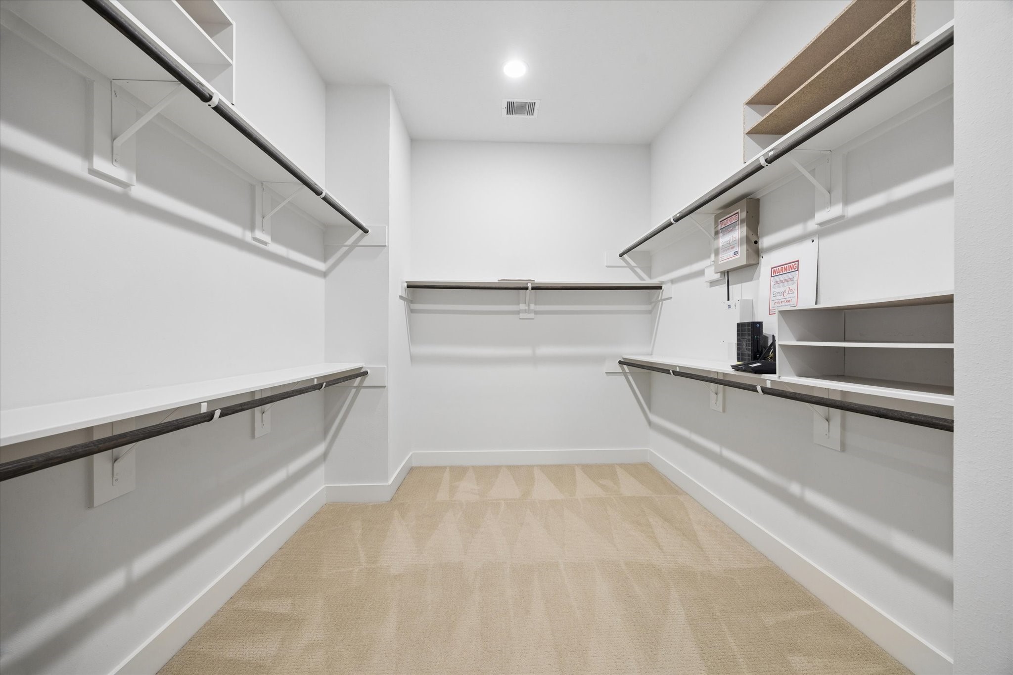 2110 Genesee Street Houston, TX 77006 - Photo 25 of 47 Large walk-in closet with built-in shelving and hanging space for organized storage.