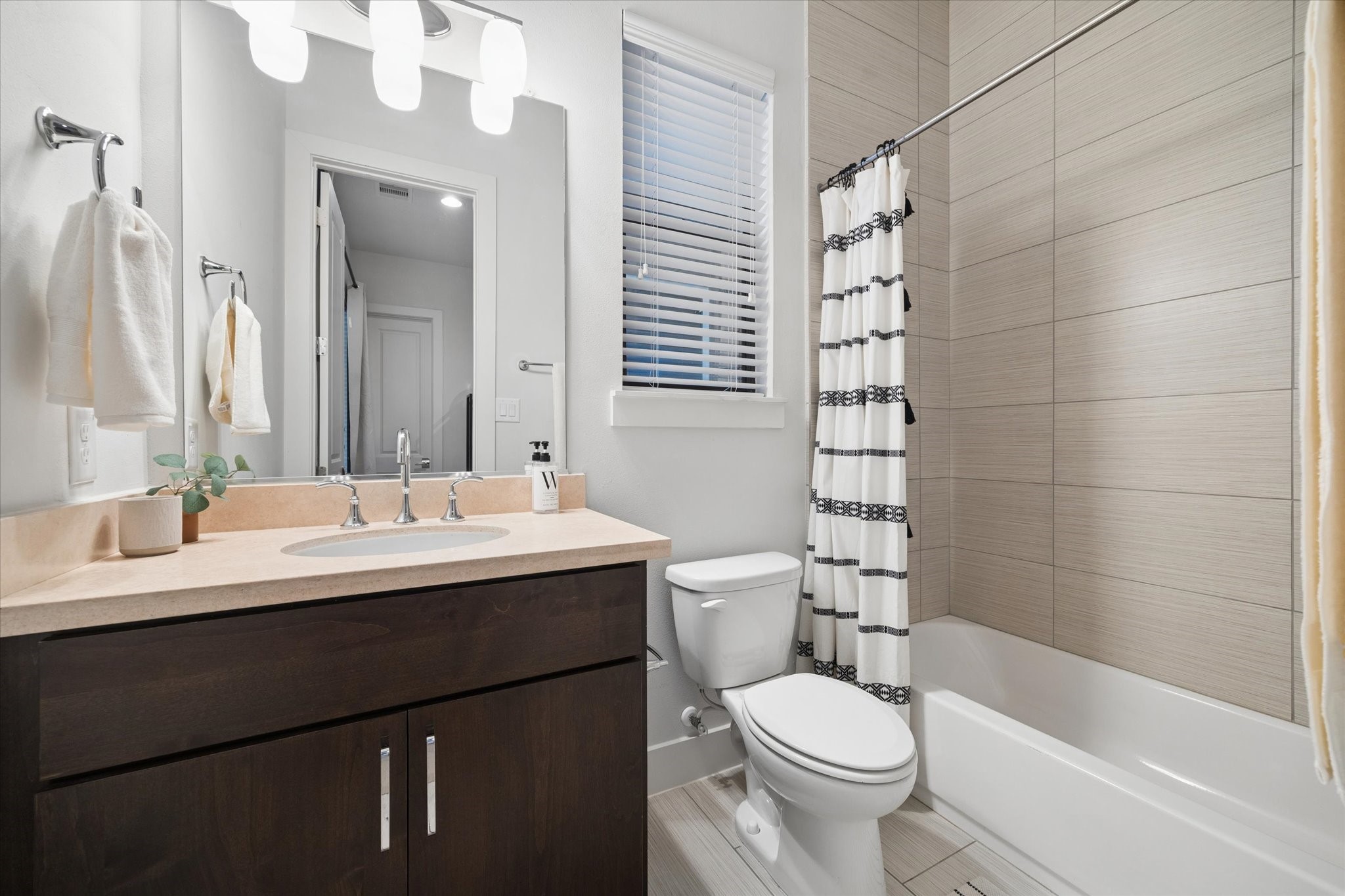 2110 Genesee Street Houston, TX 77006 - Photo 35 of 47 he secondary bathroom features clean, modern finishes with a full tub and shower, offering both comfort and convenience.