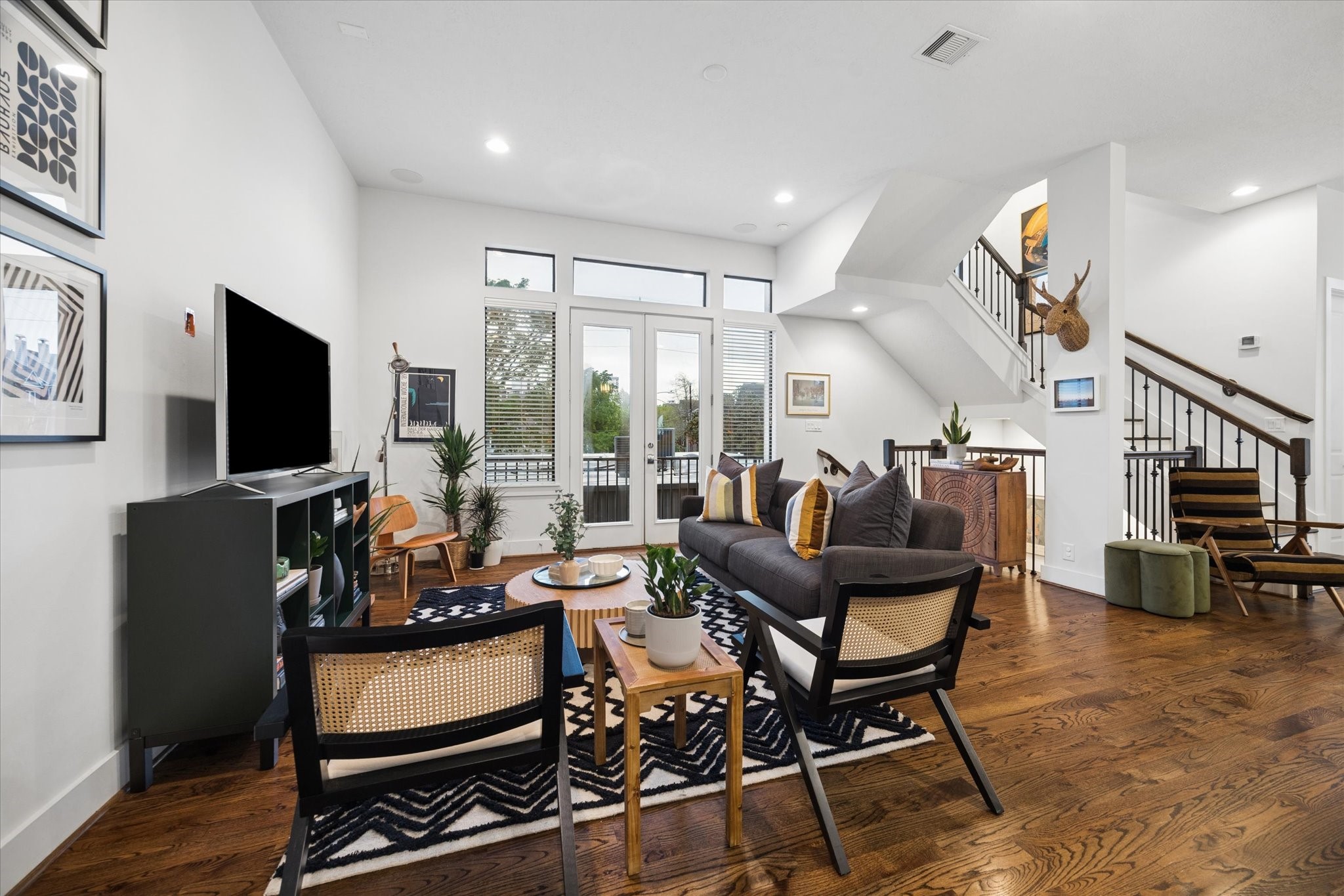 2110 Genesee Street Houston, TX 77006 - Photo 8 of 47 Open-concept living with direct access to a private balcony through full glass doors.