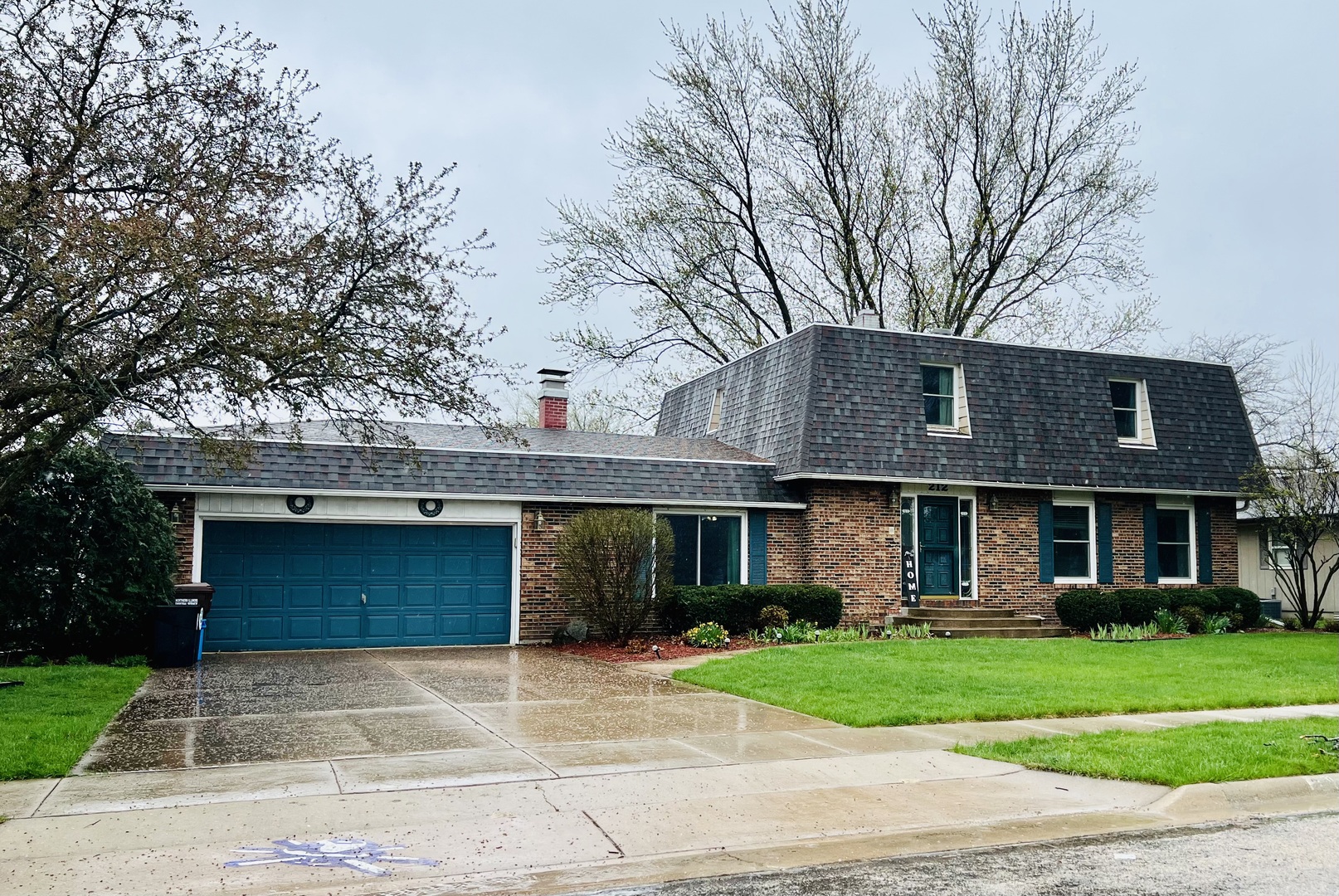 212 Drake Avenue Rochelle, IL 61068 - Photo 1 of 32 a front view of a house with a garden and trees
