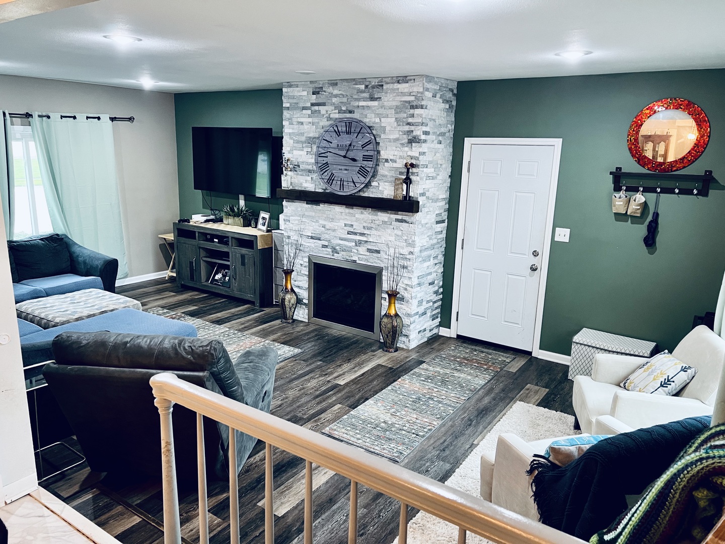 212 Drake Avenue Rochelle, IL 61068 - Photo 2 of 32 a living room with furniture a flat screen tv and a fireplace