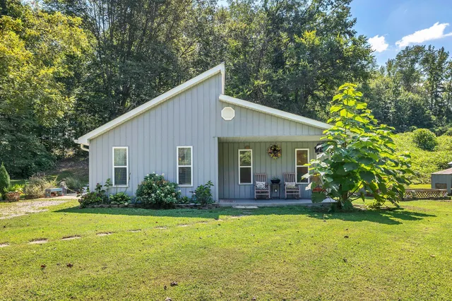 a view of a house with pool and garden