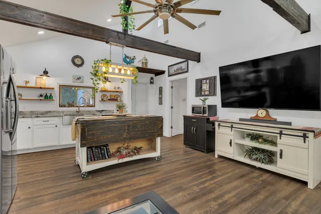 a kitchen with stainless steel appliances a stove a microwave and cabinets