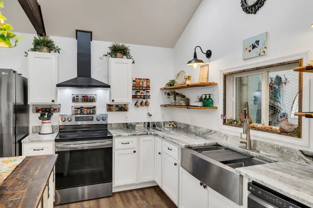a kitchen with stainless steel appliances granite countertop a stove and a sink