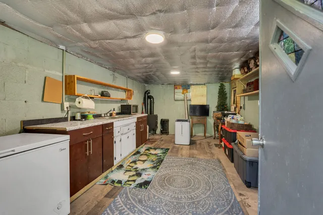 a kitchen with sink cabinets and appliances