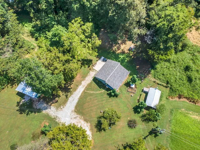 an aerial view of a house with a yard basket ball court and outdoor seating