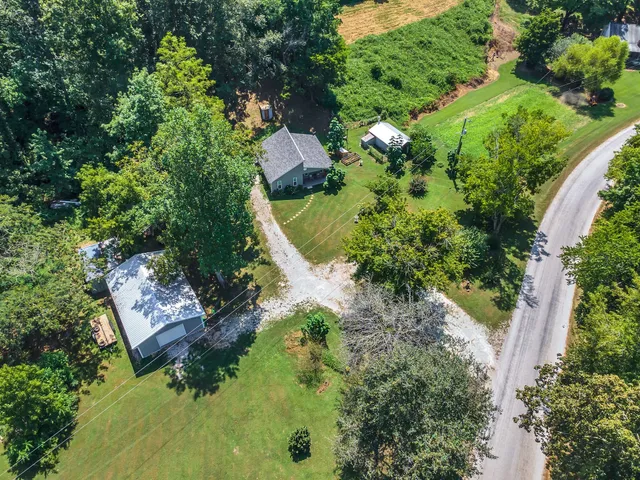 a backyard of a house with a yard and outdoor seating