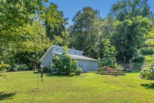 a view of a house with a yard and plants
