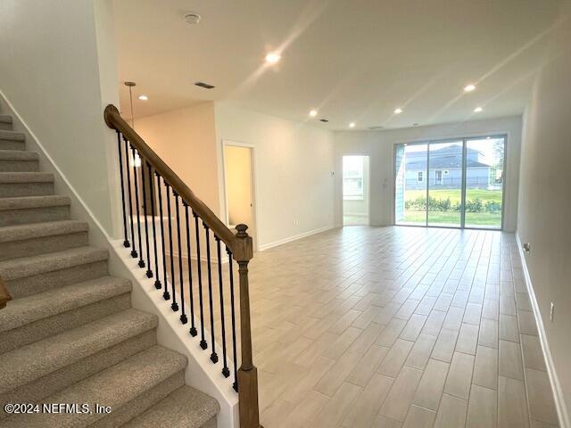 179 Misty Harbor Trace Palm Coast, FL 32137 - Photo 5 of 14 a view of an entryway with wooden floor