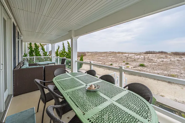 a view of a balcony dining space with furniture