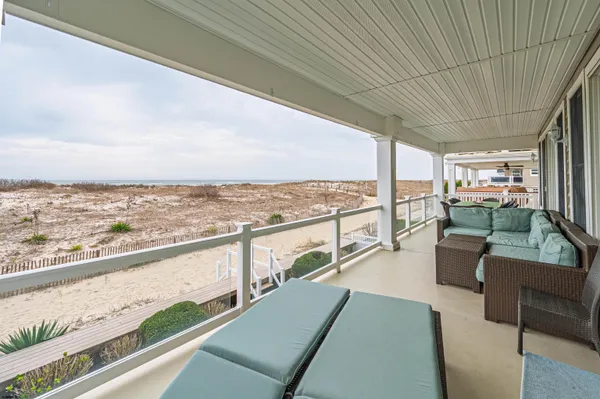 a view of a balcony with couches and wooden floor