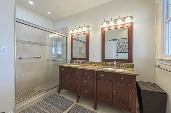 a bathroom with a granite countertop sink mirror and double