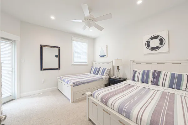 a bedroom with two beds and painting on the wall
