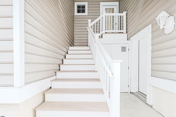 a view of entryway with wooden floor and stairs