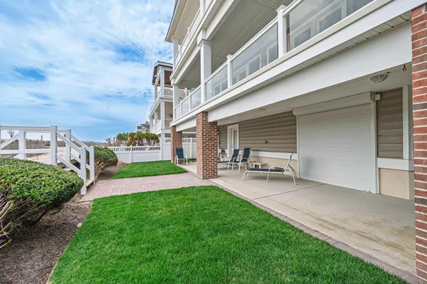 a view of a house with a yard and sitting area