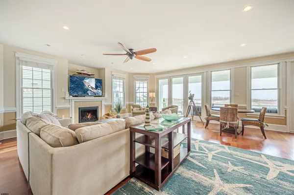 a living room with fireplace furniture and a large window