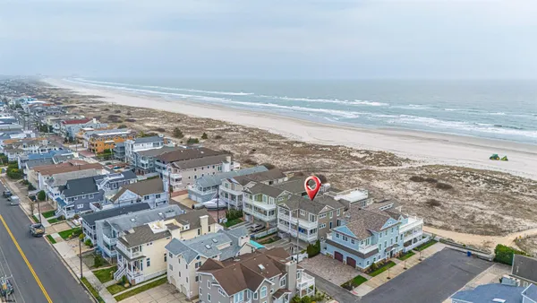 an aerial view of residential building and ocean