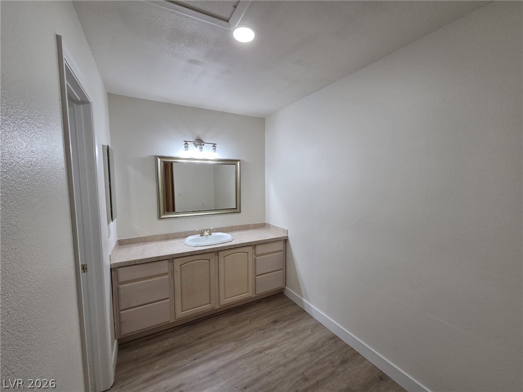 3317 Racquet Street Las Vegas, NV 89121 - Photo 6 of 23 This bathroom features a contemporary vanity with a spacious countertop and a sleek mirror.