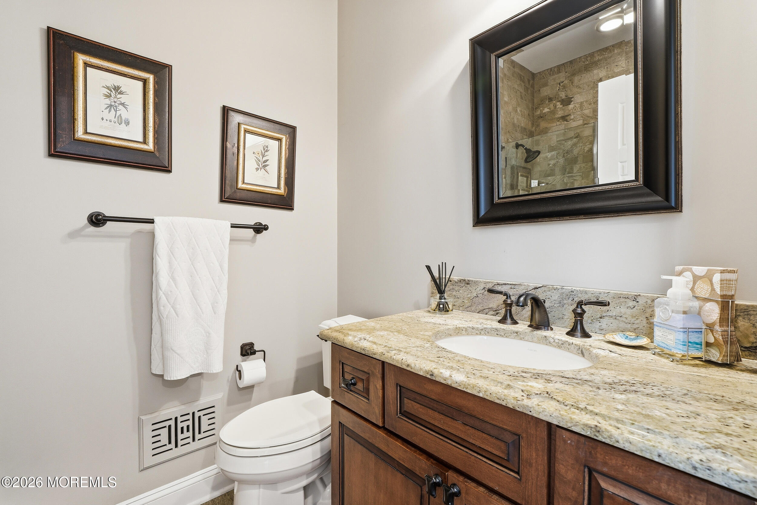 619 Bowne Road Asbury Park, NJ 07712 - Photo 29 of 69 a bathroom with a granite countertop toilet a sink and a mirror
