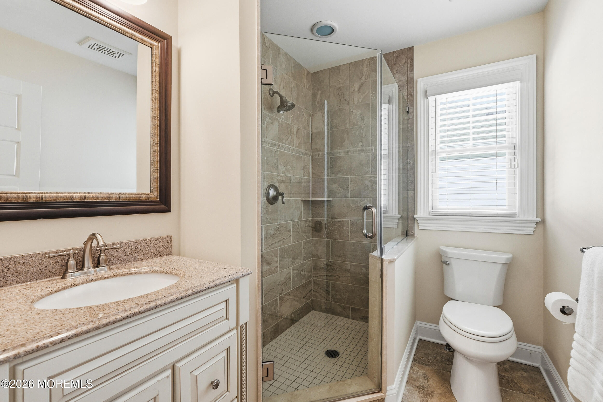 619 Bowne Road Asbury Park, NJ 07712 - Photo 45 of 69 a bathroom with a granite countertop sink a mirror a toilet and shower