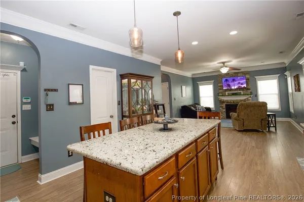 a kitchen with a dining table chairs sink and cabinets