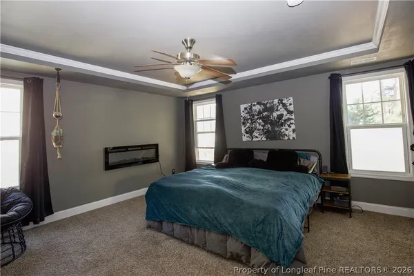 a bedroom with a large bed and a chandelier