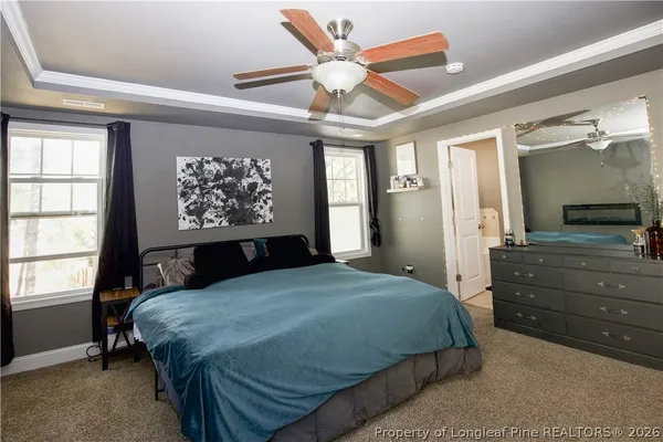 a bedroom with a bed and a television on desk