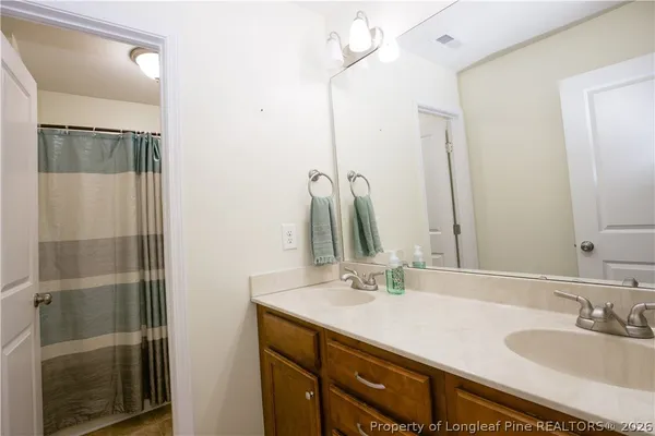 a bathroom with a white bath tub and shower