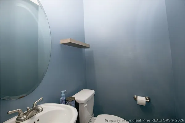 a white toilet sitting next to a bathroom sink