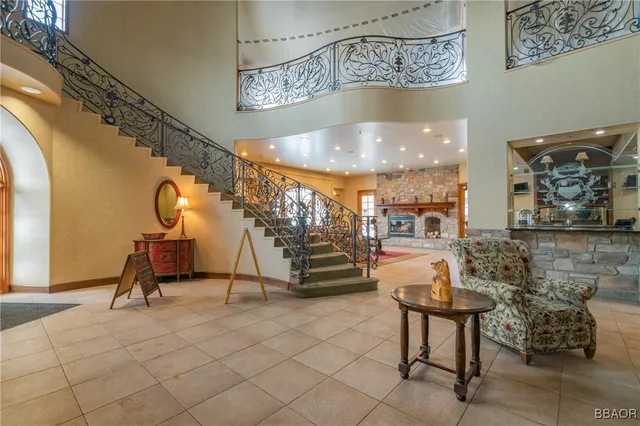 a living room with furniture a fireplace and pool table