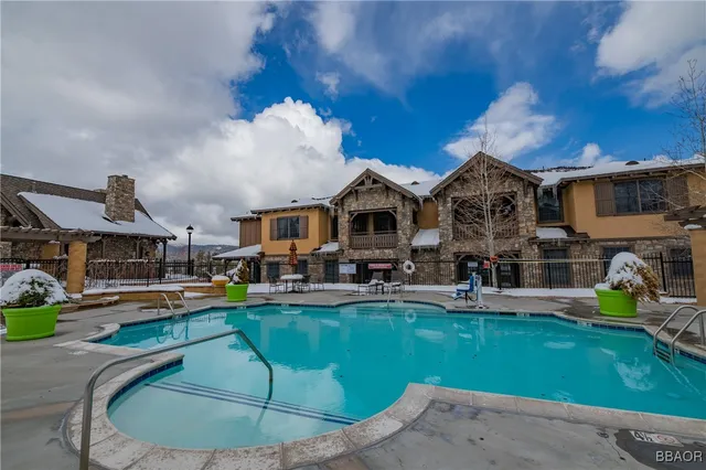 a view of a house with swimming pool and sitting area