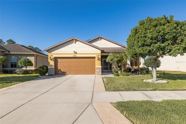 a front view of a house with a yard and garage