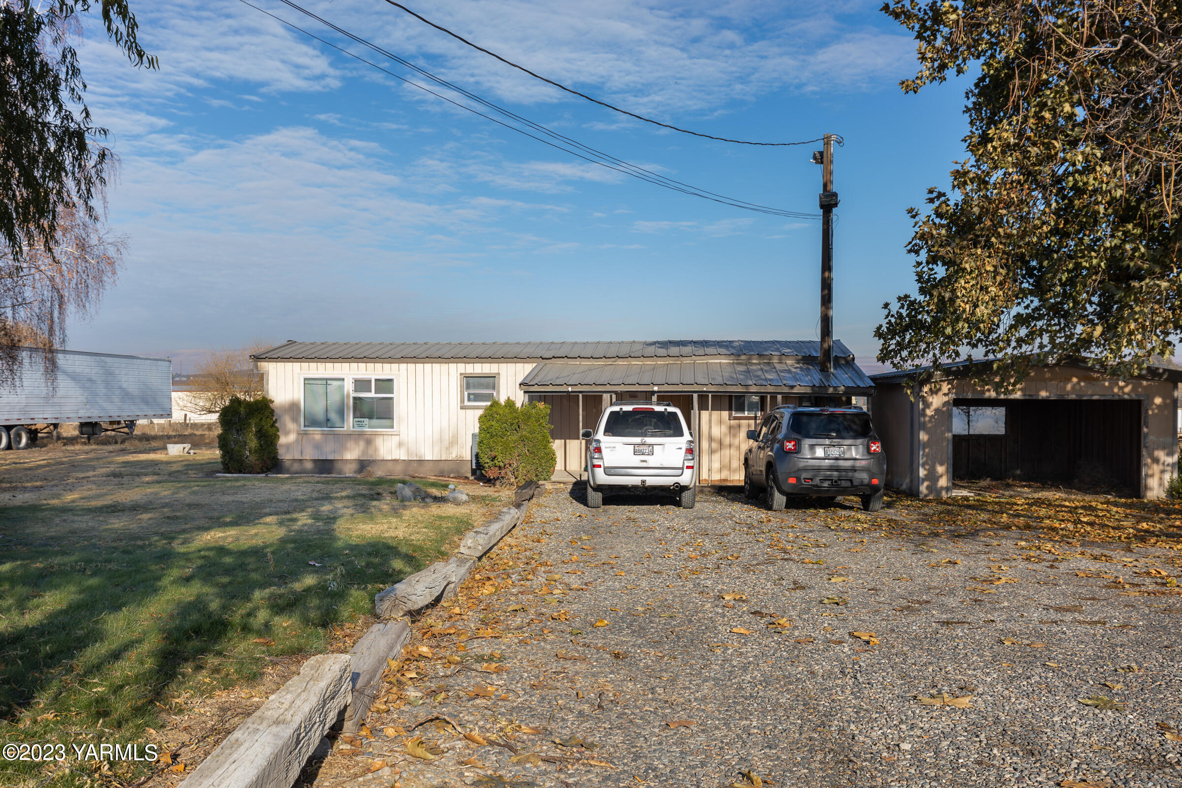 1331 Puterbaugh Road Grandview, WA 98930 - Photo 9 of 18 a view of a house with truck parked and a yard