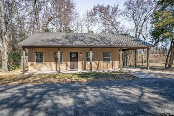 a front view of a house with a yard and porch