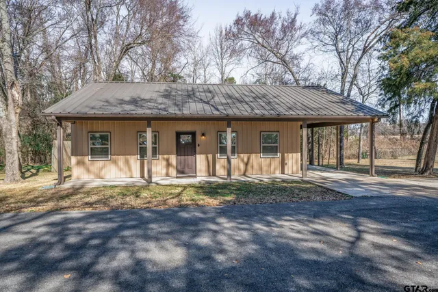 a front view of a house with a yard and porch