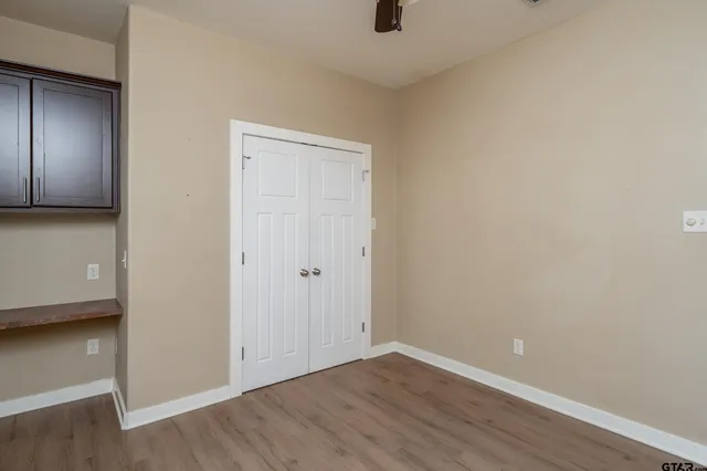 a view of an empty room with a closet