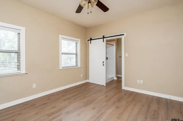 wooden floor in an empty room with a window