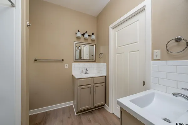 a bathroom with a sink a toilet and vanity