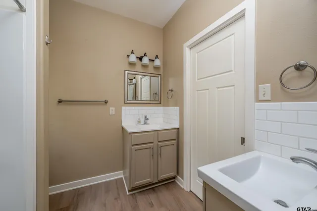 a bathroom with a sink a toilet and vanity