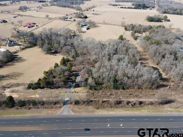 a view of a yard with wooden fence