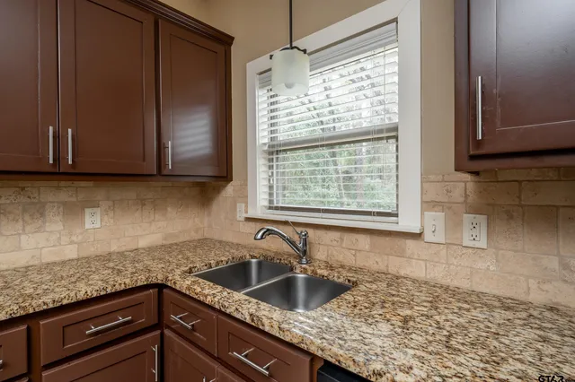 a kitchen with granite countertop a sink and a granite counter tops