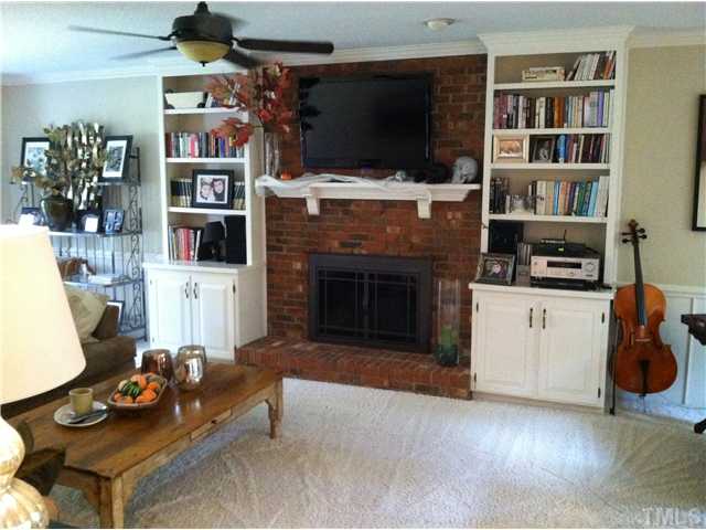 10212 Whitestone Road Raleigh, NC 27615 - Photo 13 of 15 a living room with furniture a flat screen tv and a fireplace