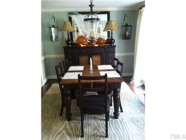 10212 Whitestone Road Raleigh, NC 27615 - Photo 4 of 15 a view of a dining room with furniture and chandelier